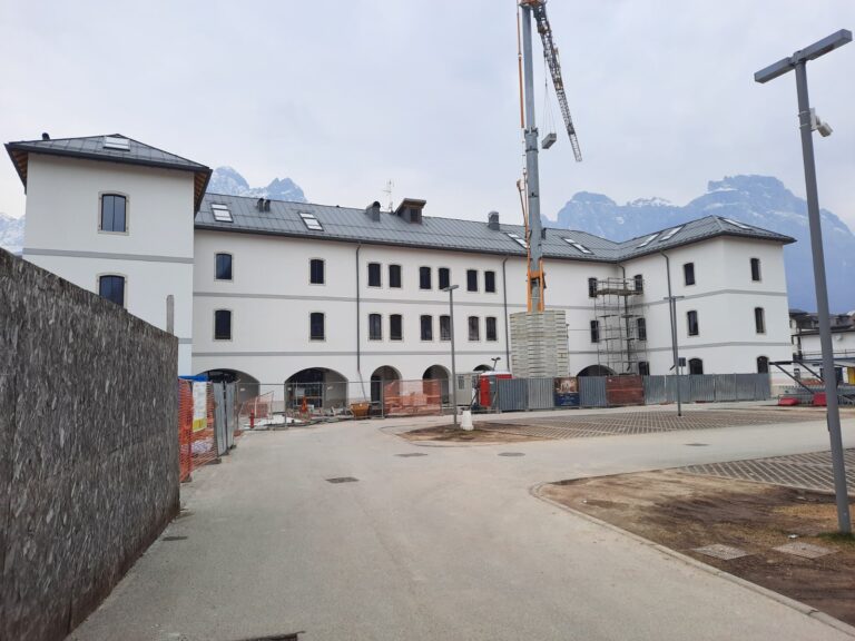 Il corpo principale della caserma di Agordo, con il portico, durante i lavori nell’area