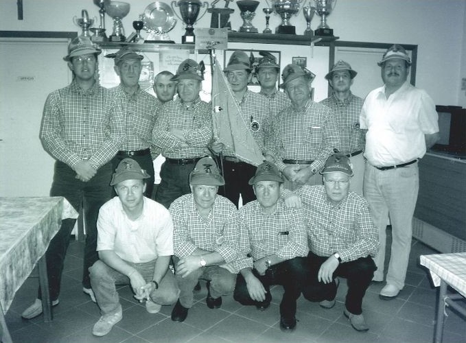 Il Consiglio Direttivo del Gruppo Alpini di Salce nel 2004 in sede: nove consiglieri in piedi e quattro accosciati, con il gagliardetto